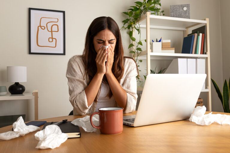 Sick woman working from home office-mobile